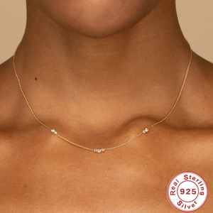 Minimalist S925 sterling silver gold necklace with three zircon stones worn on neck