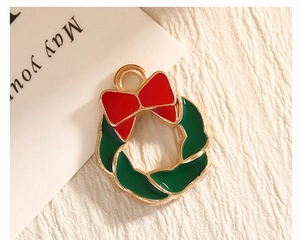 Macro shot of a Christmas wreath alloy pendant with red bow and green enamel details