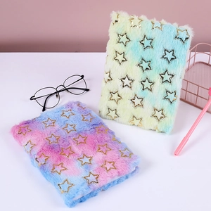 Detail of plush unicorn notebook with tie-dye gradient fur and sparkling gold stars