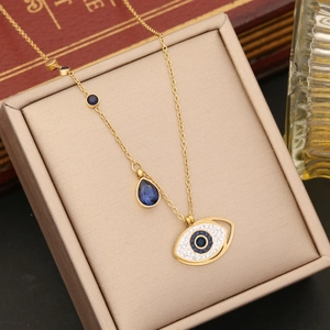 Macro shot of gold Evil Eye necklace with blue stones in a vintage jewelry box