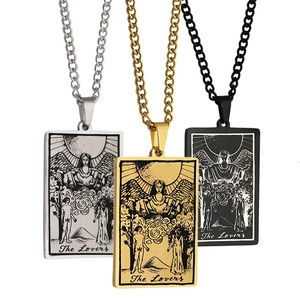 Three tarot pendants in silver, gold and matte black featuring The Lovers engraving