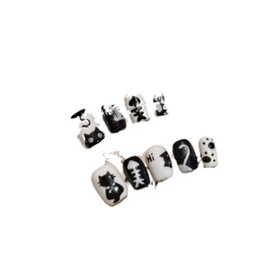 Handmade black and white cat-themed short press-on nails with cute hand-painted patterns