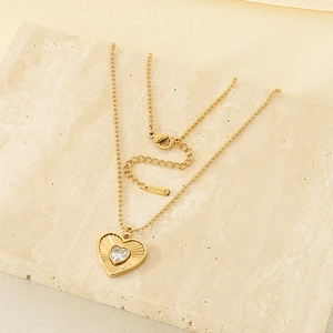 Detailed macro view of an 18K gold-plated stainless steel heart pendant with sparkling zircon