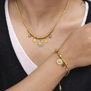 18k gold plated stainless steel turquoise necklace and bracelet set worn by a model