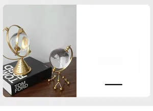 Detailed view of luxury crystal ball ornaments with textured gold metal bases and stands