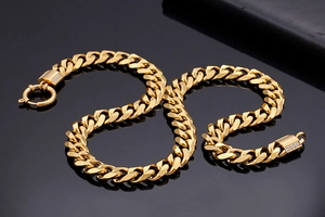 Detailed close-up of a gold-plated Cuban link chain with sparkling cubic zirconia accents