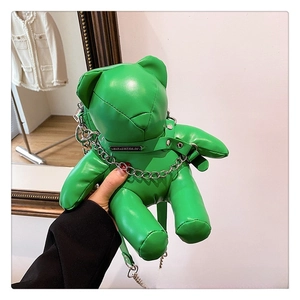 Detail view of a green bear-shaped PU leather crossbody bag with a silver chain strap