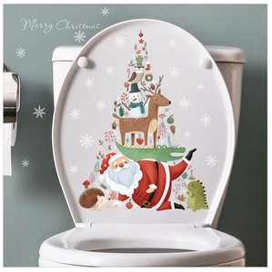 Close-up of festive Christmas toilet seat decal featuring Santa, reindeer, and snowman