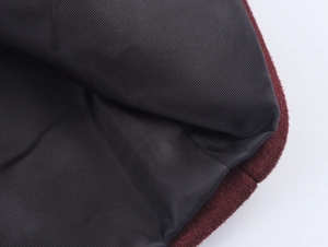 Detail shot of black twill lining stitched with burgundy suede coat fabric