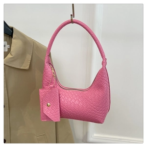 Detailed view of pink woven hobo bag with matching coin purse on khaki trench coat
