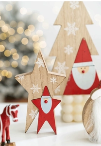 Close-up of wooden Christmas star and tree ornaments with Santa and snowflake patterns
