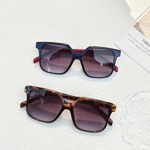 Fashionable square frame sunglasses in black and tortoise shell with purple gradient lenses