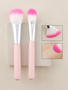 Detail of pink gradient makeup brushes with soft bristles on a stone pedestal
