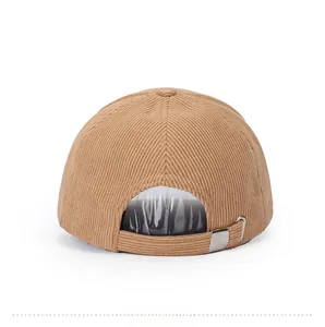 Detail view of the camel corduroy baseball cap showing the adjustable metal buckle strap