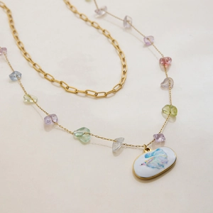 Detail of 18K gold-plated double-layer necklace with colorful natural stones and fish pendant