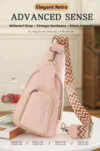 Detail of vintage pink crossbody bag with wide ethnic geometric strap and brass hardware