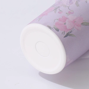 Close-up macro detail of the white non-slip bottom of a purple floral pattern tumbler