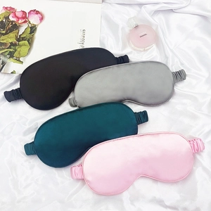 Silky sleep masks in black, silver, green, and pink on white satin background