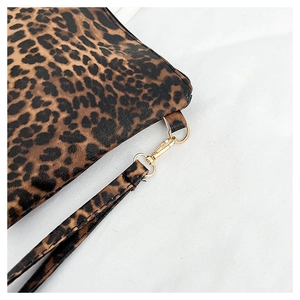 Detail of leopard print clutch with golden metal hook and detachable wrist strap