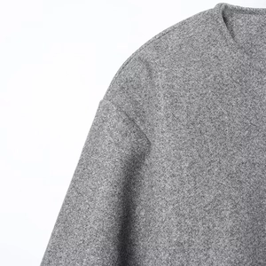 Close-up of grey wool bomber jacket collar and shoulder stitching on white background
