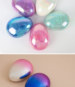 Glitter and gradient finish egg-shaped detangling hair brushes in multiple colors