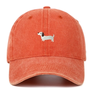 Close-up of embroidered dachshund dog on vintage washed cotton baseball cap fabric