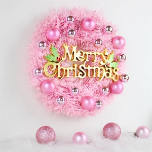 Pink plush Christmas wreath with silver ornaments and golden Merry Christmas sign