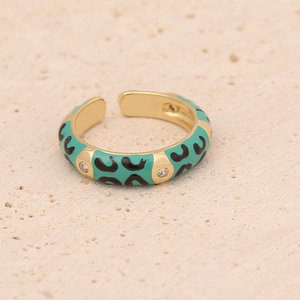 Macro detail of gold-plated leopard print ring with teal enamel and sparkling zircons