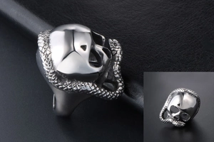 Detailed side view of silver gothic ring featuring a skull and snake design on leather