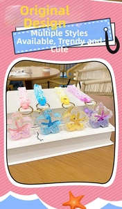 Detailed set of four cherry blossom liquid sand keychains in pink, blue, yellow, and purple