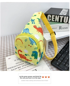 Close-up of yellow canvas kids chest bag with colorful cartoon dinosaur prints