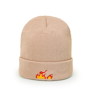 Close-up of beige knit beanie featuring detailed red and yellow flame embroidery on the cuff