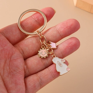 Golden keychain with rabbit, sun, and crown enamel charms for backpack accessories