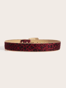Detailed view of red leopard print belt with golden bead edges and premium metal buckle