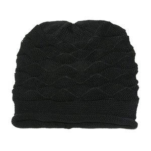 Detailed view of black knitted beanie featuring thick wave texture and ribbed edge