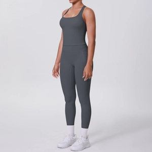 Side view of dark gray racerback sports bra and high-waist yoga leggings set on model