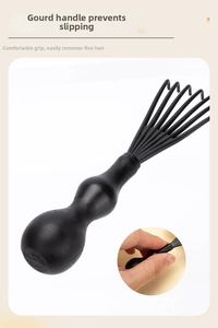 Macro detail of ergonomic black comb cleaner tool with durable rake teeth for hair removal