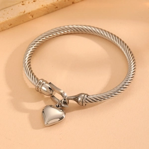 Close-up of silver titanium steel rope bracelet featuring a polished heart charm detail