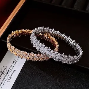 18k gold plated open bangles with sparkling cubic zirconia clusters in gold and silver