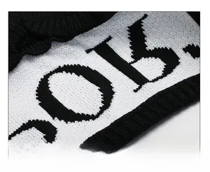 Close-up of premium knitted visor fabric showing detailed black and white weave pattern