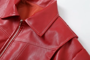 Detail of red PU leather jacket showing lapel and contrast white stitching craftsmanship