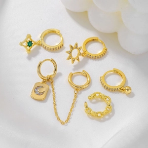 Golden moon and star earrings set with green stones and sparkling cubic zirconia