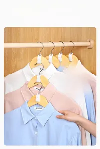 Close-up of white hanger connector hooks cascading multiple shirts for space saving