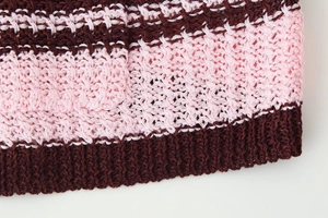 Close-up of pink and brown striped knit hem showing detailed texture and stitching