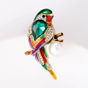 Exquisite crystal and enamel bird brooch featuring a pearl accent and vibrant rhinestones
