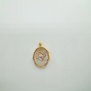 Detail of 18K gold-plated star leaf pendant with shell inlay and square cubic zirconia