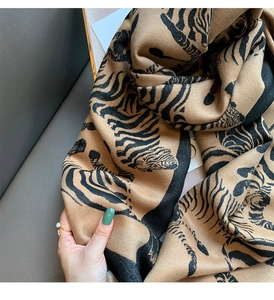 Macro detail of soft tiger print scarf texture showing high-quality woven fabric