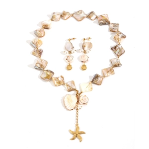 Ocean style shell jewelry set with starfish pendants, gold accents and pearls