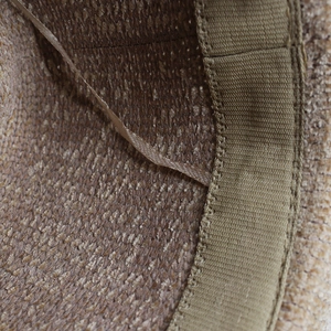 Detail of knitted fedora hat interior featuring adjustable drawstring and sweatband