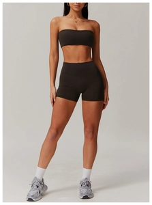 Close-up of dark brown high-waist yoga shorts and matching sports bra set for women